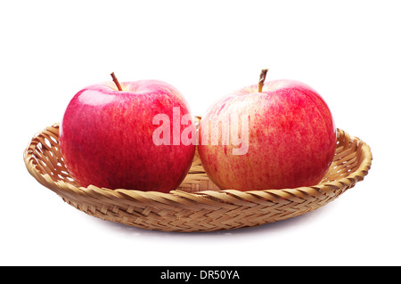 Zwei Äpfel in einem Weidenkorb auf weißem Hintergrund Stockfoto