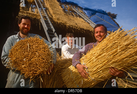 Mit Hilfe von Techniken entwickelt, über Jahrtausende hinweg, traditionelle Thatchers mit Stroh für eine Scheune Dach in Suffolk, England. Stockfoto