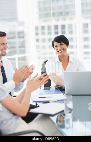 Business-Leute klatschten während in einer Besprechung Stockfoto