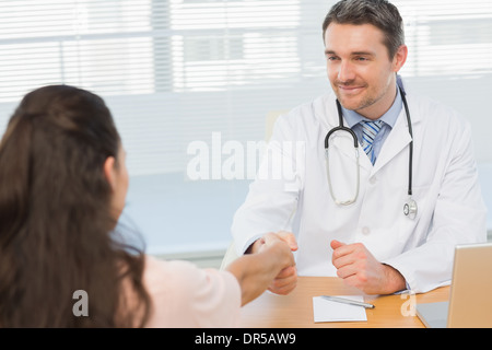 Arzt und Patient Händeschütteln in Arztpraxis Stockfoto