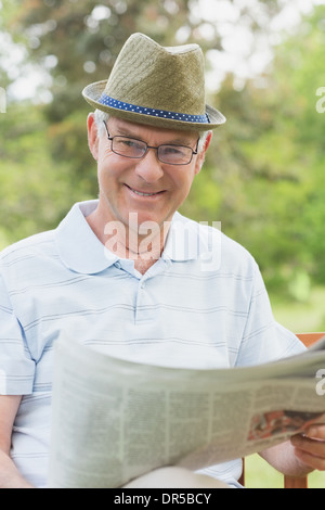 Ältere Mann liest Zeitung im park Stockfoto