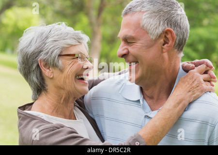 Glückliche senior Frau umarmen Mann im park Stockfoto