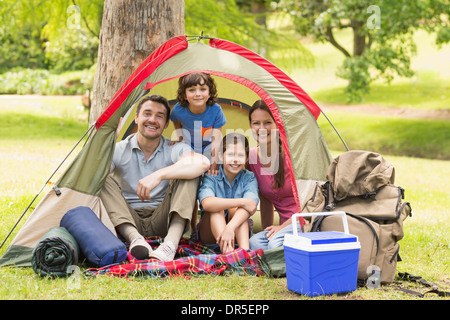 Paar mit Kinder sitzen im Zelt im park Stockfoto