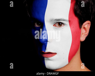 Flagge von Frankreich auf ein Gesicht eines jungen Mannes gemalt Stockfoto