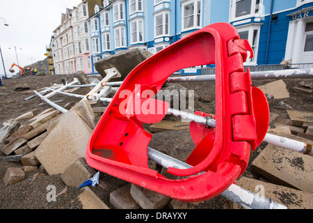 Nach einer Woche der Springfluten, Sturmfluten und Sturmwinde Kraft hat die Strandpromenade von Aberystwyth in Wales, mit Millionen von Pfund Schaden verwüstet. Die brechenden Wellen schlug ein großes Loch in den Deich und ist zusammengebrochen Aberystwyths kultigen, viktorianischen Promenade Unterschlupf, die seit über 100 Jahren stehen geblieben. Dieses Bild entstand auf Mittwoch, 8. Januar 2014, der Tag begann der Rat, zu versuchen, und deaktivieren Sie die Tausende von Tonnen Schutt Strand Meer Offroad. Stockfoto