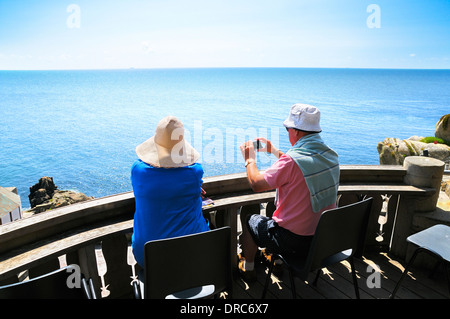 Älteres Paar mit Blick auf das Meer im Sommersonne entspannen Stockfoto