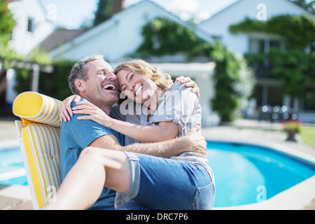 Paar entspannen im Liegestuhl am Pool Stockfoto
