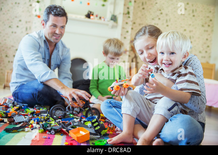 Vater und Kinder zusammen spielen Stockfoto