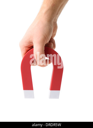 Eine Hand hält ein Magnet isoliert auf weiss, ein Objekt aufzunehmen Stockfoto