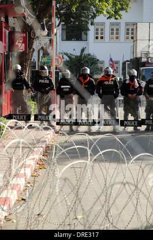 Thai Aufruhr Polizisten stehen Wache, wie Anti-Regierungs-Demonstranten während einer Kundgebung vor der Royal Thai Police Headquarte sammeln Stockfoto