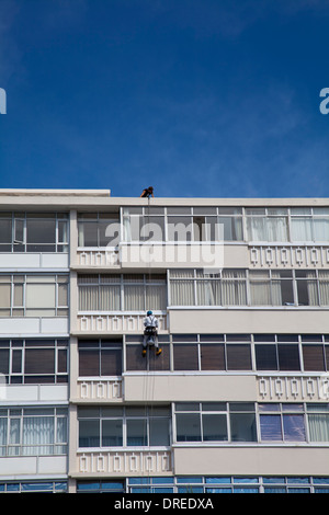 Fenster Reiniger Abseilen auf Wohnung Außenseite im Meer Punkt - Kapstadt - Süd Afrika Stockfoto