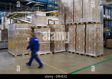 Dresden, Deutschland. 22. Januar 2014. Ein Mitarbeiter geht vorbei an Zigarette Kartons in das Fertigwarenlager der f6 Zigarettenfabrik in Dresden, Deutschland, 22. Januar 2014. Foto: Arno Burgi/Dpa/Alamy Live-Nachrichten Stockfoto