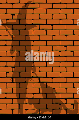 Einer roten Backsteinmauer zeigt die Silhouette einer Hexe und ihre Katze. Stockfoto