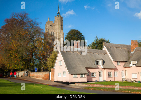 Die rosa Hütten unter Str. Marys Kirche, Cavendish, Suffolk, England. Stockfoto