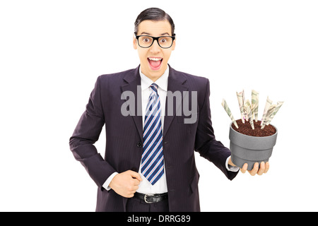 Junger Geschäftsmann mit einem Blumentopf mit US-Dollar in es isoliert auf weißem Hintergrund Stockfoto