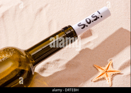 Wort SOS steht in der Notiz in der Flasche Stockfoto