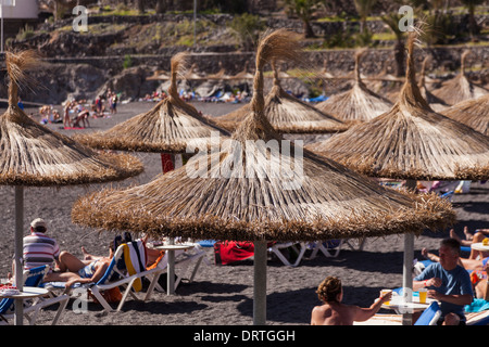 Strohschirm Schattierungen auf der Playa Ajabo in Callao Salvaje, Teneriffa, Kanarische Inseln, Spanien gewebt. Stockfoto