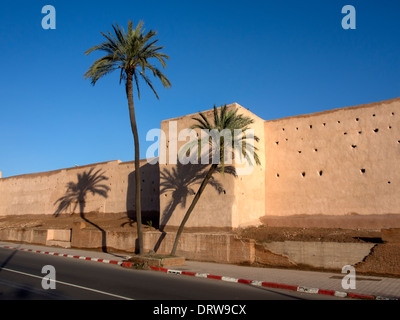 MARRAKESCH, MAROKKO - 21. JANUAR 2014: Palmen und Schatten an den Mauern und Stadtmauern Stockfoto