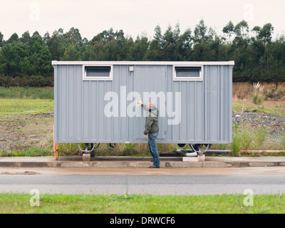 Mann, die Eröffnung einer Hütte-Website im Freien an einem bewölkten Tag Stockfoto