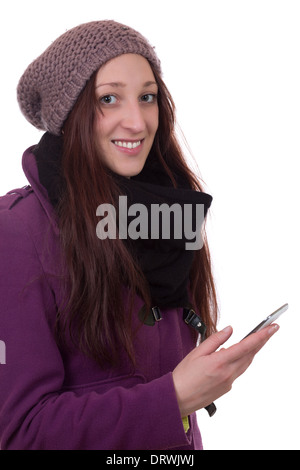 Junge Frau im Winter mit einem Mobiltelefon, isoliert auf weißem Hintergrund Stockfoto