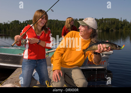 Ein Vater hält eine Sommer-Zander seine Tochter gefangen. Stockfoto