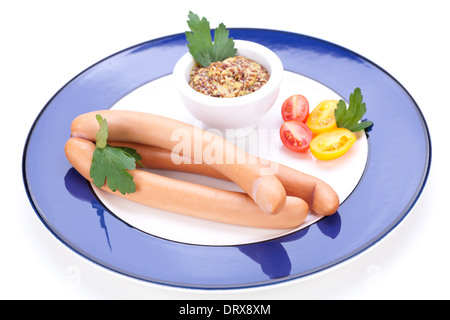 Drei kalt geräucherte Würstchen oder Wiener Würstchen serviert auf einem Teller mit einem Sprung in eine kleine Schüssel geben und in Scheiben geschnittenen Kirschtomaten auf ein weißes Studio-Hintergrund Stockfoto