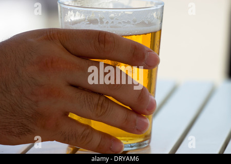 Nahaufnahme des männlichen Hand mit Glas Bier. Stockfoto