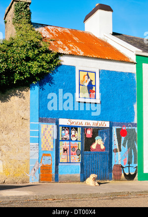 Hund vor Wandmalerei Raubfischshop in Fischen Dorf Kinvara am südlichen Ufer der Bucht von Galway, Irland Stockfoto