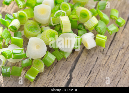 gehackten Frühlingszwiebeln auf alten Holztisch Stockfoto