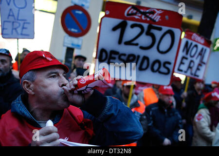 Madrid, Spanien. 6. Februar 2014. Ein Demonstrant macht Lärm wie andere Banner zeigen wo es schriftliche '' 1250 Entlassungen '' und '' Nein, ERE'' während einer Demonstration gegen den Softdrink-Hersteller in Madrid, Spanien, Donnerstag, 6. Februar 2014. Coca-Cola-Arbeiter sind auf einen unbefristeten Streik protestieren Coca-Cola Iberian Partners Pläne schließen vier seiner 11 Pflanzen und einige 1.253 Arbeiter entlassen. Bildnachweis: Rodrigo Garcia/NurPhoto/ZUMAPRESS.com/Alamy Live-Nachrichten Stockfoto