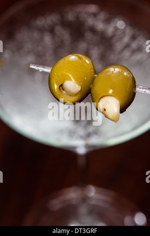 Knoblauch gefüllte Martini Oliven statt bei einem Cocktail im Hintergrund Stockfoto