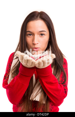 Junge asiatische Frau gekleidet für den Winter weht ein Kuss oder ein Silvester-Wunsch Stockfoto