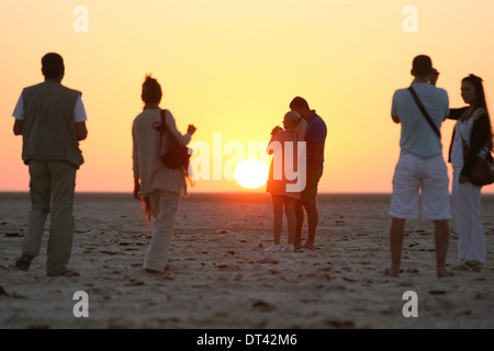 Touristen beobachten und fotografieren den Sonnenaufgang am Chott El Jerid, einem großen Salzsee in Süd-Tunesien. Stockfoto