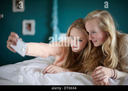 Zwei Mädchen im Teenageralter unter Selfie im Schlafzimmer Stockfoto