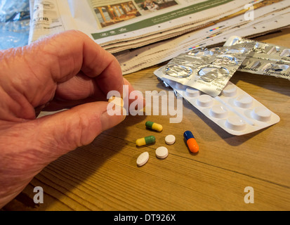 Älterer Mann mit Auswahl an Pillen, Tabletten und Kapseln. Tägliche Dosis des Medikaments. Stockfoto