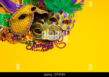 Eine festliche, bunte Gruppe von Fastnacht oder Karneval Masken auf einem gelben Hintergrund. Venezianische Masken. Stockfoto