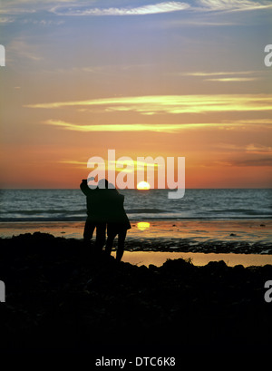 Paar einen Sonnenuntergang an der Küste bei Birling Gap in der South Downs National Park, East Sussex. Stockfoto