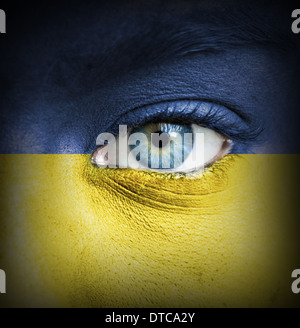 Menschliches Gesicht gemalt mit Flagge der Ukraine Stockfoto