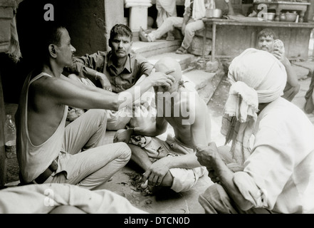 Rituelle Beerdigung Haarschnitt am Manikarnika Feuerbestattung Ghat Varanasi Benares in Uttar Pradesh in Indien in Südasien. Haareschneiden Tod Fluss Ganges Reisen Stockfoto