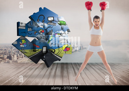 Zusammengesetztes Bild sicher Fit braun behaart Modells Sportswear springen und tragen Boxhandschuhe Stockfoto