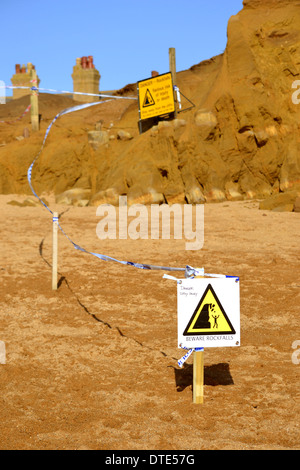 Warnschilder und Polizei Klebeband nach Steinschlag am Strand von West Bay, in der Nähe von Bridport, Dorset, England, UK, Februar 2014 Stockfoto