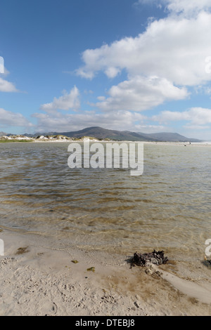 Tidal Lagoon am Strand von Noordhoek, mit Kommetjie im Hintergrund Stockfoto