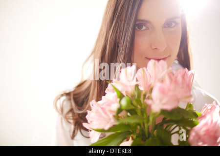 Porträt von reizenden Dame mit Blumenstrauß Blick in die Kamera Stockfoto