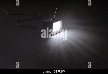 Ein Retro-TV-Gerät in einem leeren, dunklen Innenraum Stockfoto