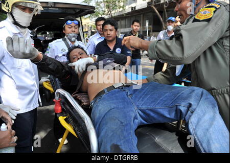 Bangkok, Thailand. 18. Februar 2014. Eine verletzte Anti-Regierungs-Demonstranten erfolgt bei Zusammenstößen mit der thailändischen Polizei in der Nähe von Democracy Monument in Bangkok, der Hauptstadt von Thailand, 18. Februar 2014 in einen Krankenwagen. Thailändische Polizei am Dienstagmorgen begann, von Anti-Regierungs-Demonstranten zurückfordern fünf Standorten in der Hauptstadt Bangkok, Rallye und ließ drei Tote und 59 Verletzte bei Zusammenstößen. Bildnachweis: Gao Jianjun/Xinhua/Alamy Live-Nachrichten Stockfoto