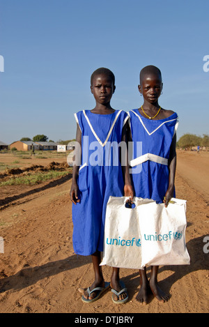 Uganda Karamoja Kotido, Karimojong, pastorale Stamm, Kinder auf dem Weg zur Schule, ein UNICEF-Plastikbeutel für Bücher tragen Stockfoto