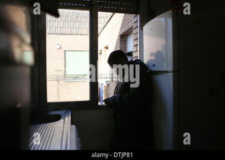 Madrid, Spanien. 19. Februar 2014. 29-jährige Maria Menendez Melendez prüft ihr Telefon in der Küche, wie sie wartet darauf, von ihrem Haus in Madrid, Spanien, Mittwoch, 19. Februar 2014 geräumt werden. Maria Menendez Melendez 29-jährige aus der Dominikanischen Republik lebt seit acht Jahren mit seinem Partner Carlos und ihren zwei Kindern, Raquel ConcepciÃƒÂ³n Menendez 9 jährige und Jean Carlos Concepcion Menendez 6 Jahre alt, in einer Wohnung Eigentum von '' La CAM-Sabadell'' mit denen sie vertraglich einer Hypothek, die für 6 Jahre nicht gezahlt haben. Bevor er arbeitete arbeitslos Maria als ein Kitchener in Stockfoto