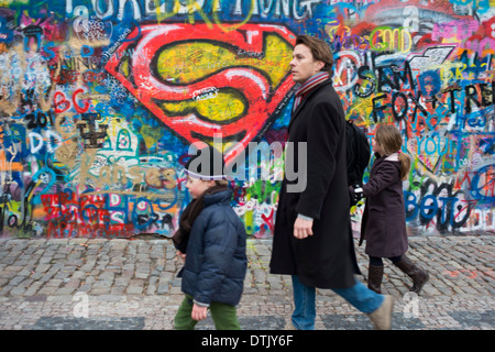 Eine Mädchen geht vorbei an der John-Lennon-Mauer im Zentrum von Prag. Die John-Lennon-Mauer ist eine Mauer, die einst einen Großteil der könnte Stockfoto
