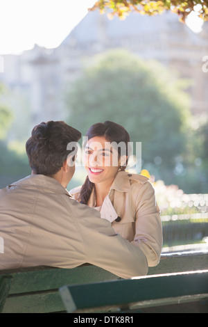 Paar sprechen auf Parkbank Stockfoto