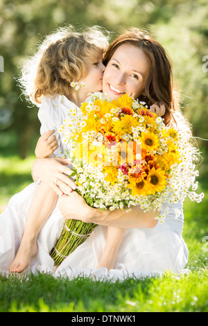 Frau und Kind hält Blumenstrauss Stockfoto